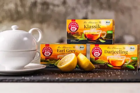 Weiße Teekanne, Zitrone und Teekanne-Packungen: Klassik, Earl Grey, Darjeeling. Eine Tee-Wirkung-Tabelle wäre hier passend.